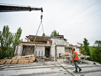 Workers are reconstructing a residential building damaged by a Russian missile strike on the night of March 2, 2023, at 67 Nezalezhnoyi Ukra...