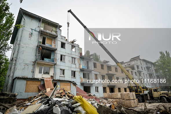 Workers are reconstructing a residential building damaged by a Russian missile strike on the night of March 2, 2023, at 67 Nezalezhnoyi Ukra...