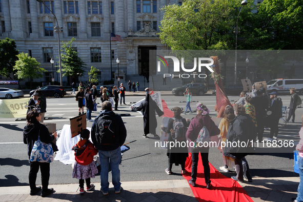 Climate activists with the Extinction Rebellion DC organization stage a protest outside of the John A. Wilson building in Washington, D.C. o...