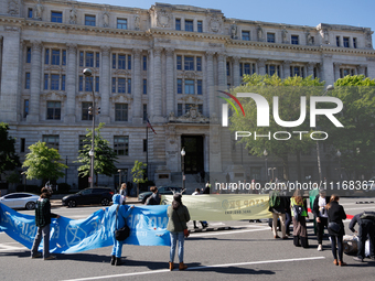 Climate activists with the Extinction Rebellion DC organization stage a protest outside of the John A. Wilson building in Washington, D.C. o...