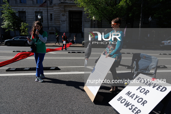 Climate activists with the Extinction Rebellion DC organization stage a protest outside of the John A. Wilson building in Washington, D.C. o...