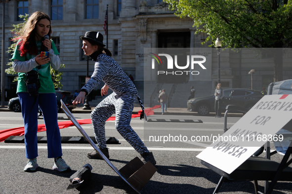 Climate activists with the Extinction Rebellion DC organization stage a protest outside of the John A. Wilson building in Washington, D.C. o...