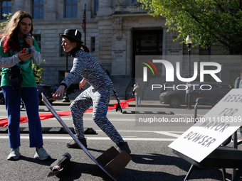 Climate activists with the Extinction Rebellion DC organization stage a protest outside of the John A. Wilson building in Washington, D.C. o...