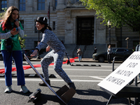 Climate activists with the Extinction Rebellion DC organization stage a protest outside of the John A. Wilson building in Washington, D.C. o...