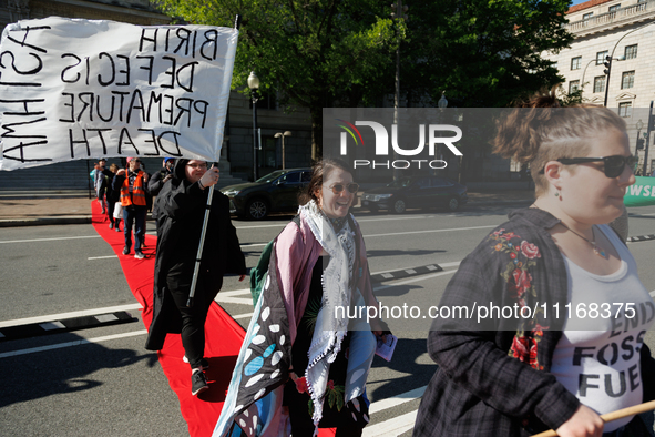 Climate activists with the Extinction Rebellion DC organization stage a protest outside of the John A. Wilson building in Washington, D.C. o...