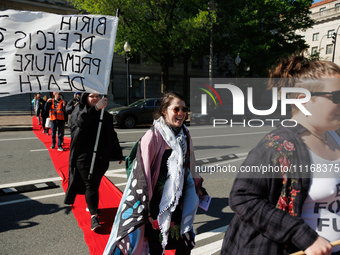 Climate activists with the Extinction Rebellion DC organization stage a protest outside of the John A. Wilson building in Washington, D.C. o...