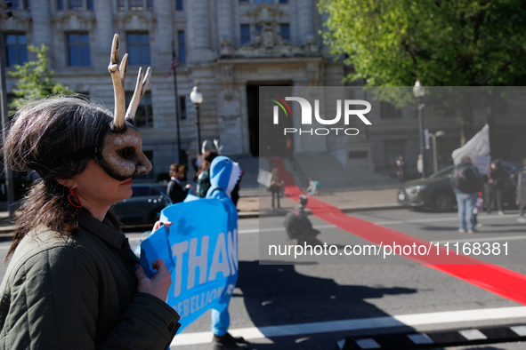 Climate activists with the Extinction Rebellion DC organization roll out a red carpet for Mayor Muriel Bowser during a protest outside of th...