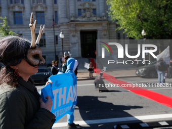 Climate activists with the Extinction Rebellion DC organization roll out a red carpet for Mayor Muriel Bowser during a protest outside of th...