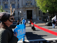 Climate activists with the Extinction Rebellion DC organization roll out a red carpet for Mayor Muriel Bowser during a protest outside of th...