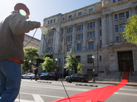 Climate activists with the Extinction Rebellion DC organization roll out a red carpet for Mayor Muriel Bowser during a protest outside of th...