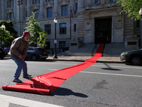 Climate activists with the Extinction Rebellion DC organization roll out a red carpet for Mayor Muriel Bowser during a protest outside of th...