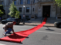 Climate activists with the Extinction Rebellion DC organization roll out a red carpet for Mayor Muriel Bowser during a protest outside of th...