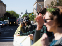 Climate activists with the Extinction Rebellion DC organization wear animal masks while marching to the John A. Wilson building in Washingto...