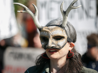 Climate activists with the Extinction Rebellion DC organization wear animal masks while marching to the John A. Wilson building in Washingto...