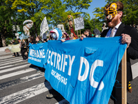 Climate activists with the Extinction Rebellion DC organization wear animal masks while marching to the John A. Wilson building in Washingto...