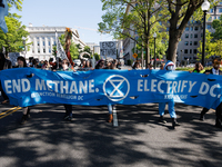 Climate activists with the Extinction Rebellion DC organization wear animal masks while marching to the John A. Wilson building in Washingto...