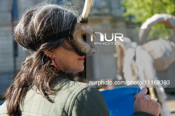 Climate activists with the Extinction Rebellion DC organization wear animal masks while marching to the John A. Wilson building in Washingto...