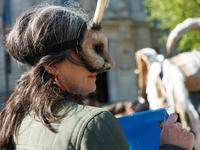 Climate activists with the Extinction Rebellion DC organization wear animal masks while marching to the John A. Wilson building in Washingto...