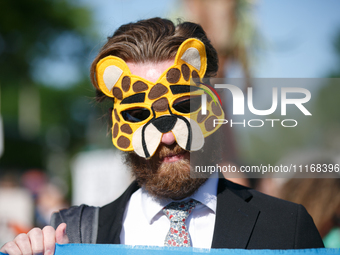 Climate activists with the Extinction Rebellion DC organization wear animal masks while marching to the John A. Wilson building in Washingto...