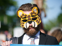 Climate activists with the Extinction Rebellion DC organization wear animal masks while marching to the John A. Wilson building in Washingto...