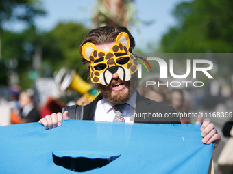 Climate activists with the Extinction Rebellion DC organization wear animal masks while marching to the John A. Wilson building in Washingto...