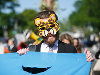 Climate activists with the Extinction Rebellion DC organization wear animal masks while marching to the John A. Wilson building in Washingto...