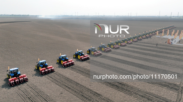 Seeders are lining up to sow seeds at a planting base in Shenyang, Liaoning Province, China, on April 22, 2024. 