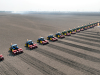 Seeders are lining up to sow seeds at a planting base in Shenyang, Liaoning Province, China, on April 22, 2024. (