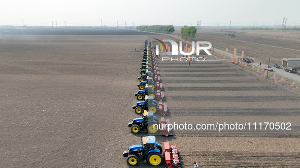 Seeders are lining up to sow seeds at a planting base in Shenyang, Liaoning Province, China, on April 22, 2024. 