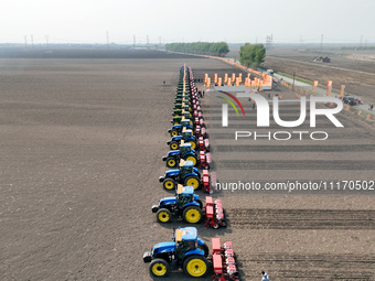 Seeders are lining up to sow seeds at a planting base in Shenyang, Liaoning Province, China, on April 22, 2024. (