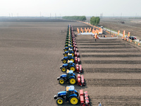 Seeders are lining up to sow seeds at a planting base in Shenyang, Liaoning Province, China, on April 22, 2024. (