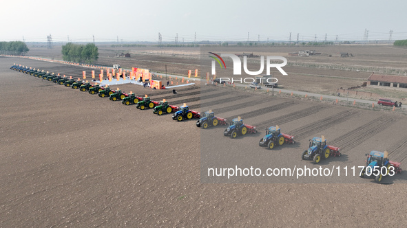 Seeders are lining up to sow seeds at a planting base in Shenyang, Liaoning Province, China, on April 22, 2024. 