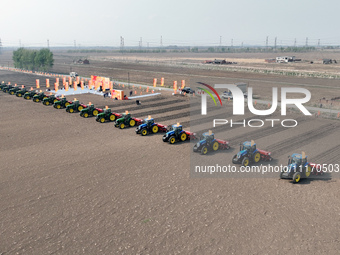 Seeders are lining up to sow seeds at a planting base in Shenyang, Liaoning Province, China, on April 22, 2024. (