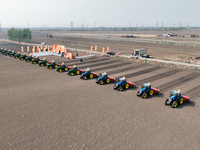 Seeders are lining up to sow seeds at a planting base in Shenyang, Liaoning Province, China, on April 22, 2024. (