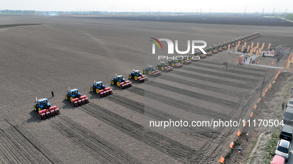 Seeders are lining up to sow seeds at a planting base in Shenyang, Liaoning Province, China, on April 22, 2024. 