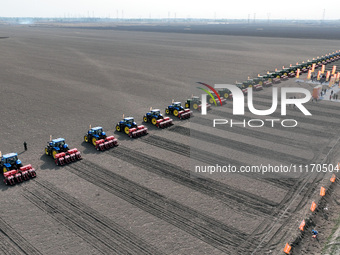 Seeders are lining up to sow seeds at a planting base in Shenyang, Liaoning Province, China, on April 22, 2024. (