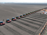 Seeders are lining up to sow seeds at a planting base in Shenyang, Liaoning Province, China, on April 22, 2024. (