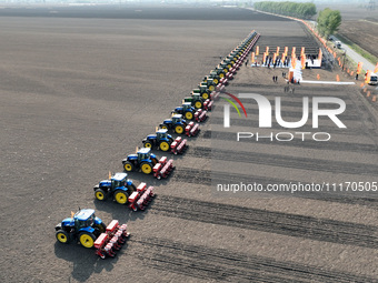 Seeders are lining up to sow seeds at a planting base in Shenyang, Liaoning Province, China, on April 22, 2024. (