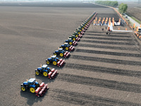 Seeders are lining up to sow seeds at a planting base in Shenyang, Liaoning Province, China, on April 22, 2024. (