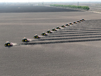 Seeders are lining up to sow seeds at a planting base in Shenyang, Liaoning Province, China, on April 22, 2024. (