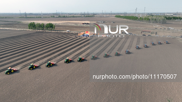 Seeders are lining up to sow seeds at a planting base in Shenyang, Liaoning Province, China, on April 22, 2024. 