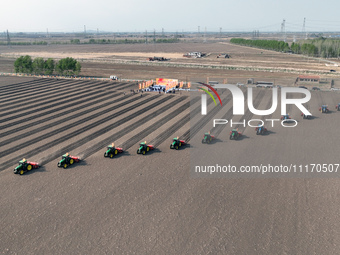 Seeders are lining up to sow seeds at a planting base in Shenyang, Liaoning Province, China, on April 22, 2024. (