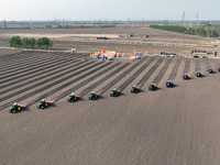 Seeders are lining up to sow seeds at a planting base in Shenyang, Liaoning Province, China, on April 22, 2024. (