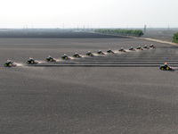 Seeders are lining up to sow seeds at a planting base in Shenyang, Liaoning Province, China, on April 22, 2024. (