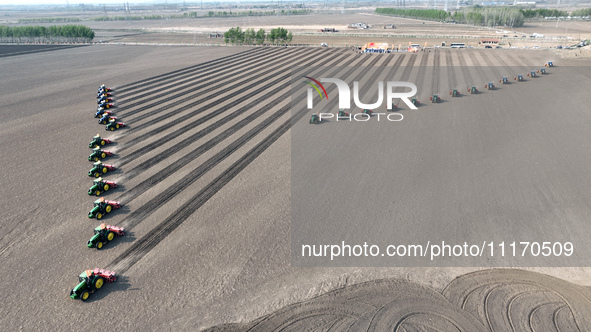 Seeders are lining up to sow seeds at a planting base in Shenyang, Liaoning Province, China, on April 22, 2024. 