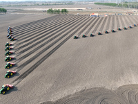 Seeders are lining up to sow seeds at a planting base in Shenyang, Liaoning Province, China, on April 22, 2024. (