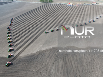 Seeders are lining up to sow seeds at a planting base in Shenyang, Liaoning Province, China, on April 22, 2024. (