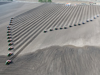 Seeders are lining up to sow seeds at a planting base in Shenyang, Liaoning Province, China, on April 22, 2024. (