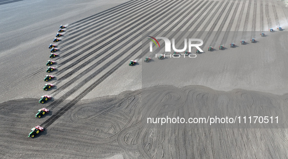 Seeders are lining up to sow seeds at a planting base in Shenyang, Liaoning Province, China, on April 22, 2024. 