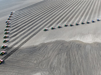 Seeders are lining up to sow seeds at a planting base in Shenyang, Liaoning Province, China, on April 22, 2024. (